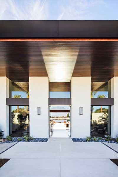 entry with recessed lighting and upright lights on either side of 8' entry doors.